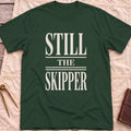 Front view of the forest green Still the Skipper T-Shirt with the words Still the Skipper in cream serif capitals.