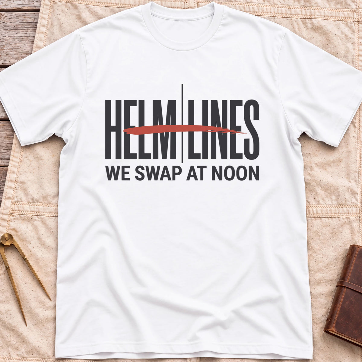 Front view of the white Swap at Noon T-Shirt with the words Helm and Lines split by a vertical line and a red brushstroke, above We Swap at Noon.