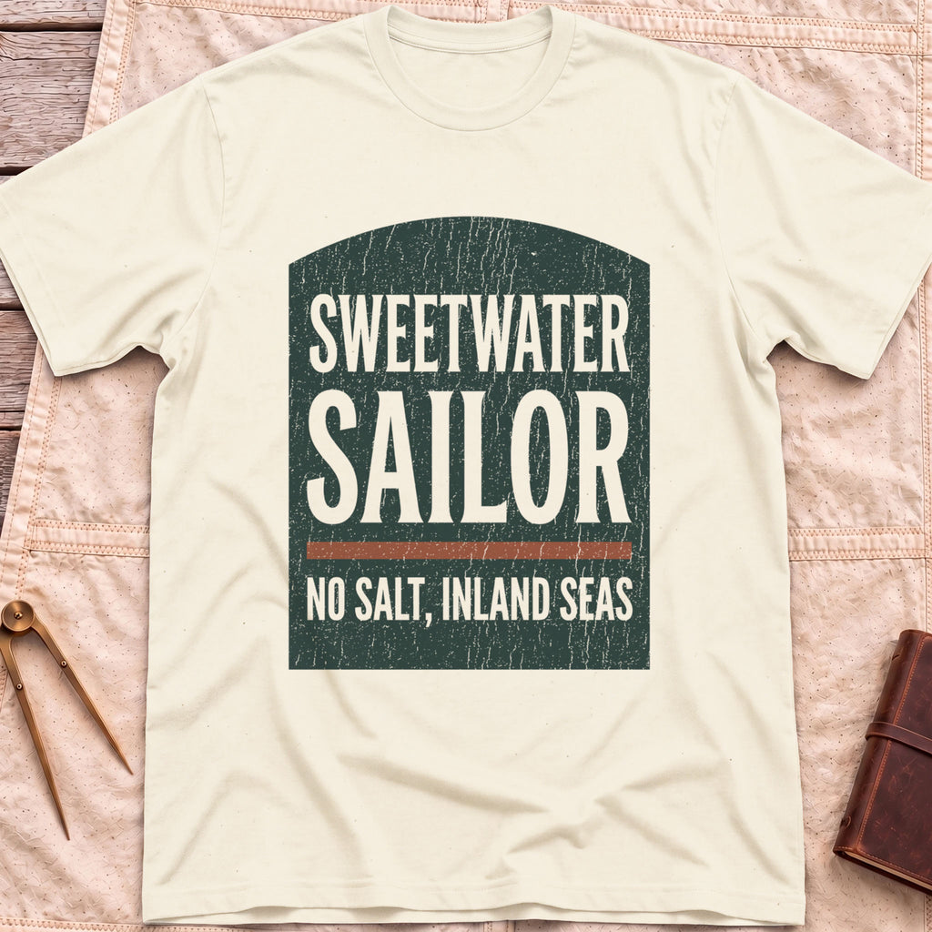 Front view of the natural Sweetwater Sailor T-Shirt with an arched green panel reading Sweetwater Sailor above No Salt, Inland Seas.