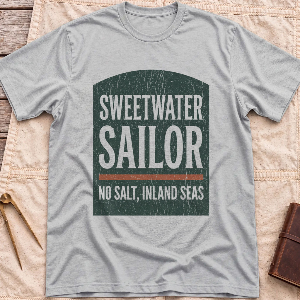 Front view of the sport grey Sweetwater Sailor T-Shirt with an arched green panel reading Sweetwater Sailor above No Salt, Inland Seas.