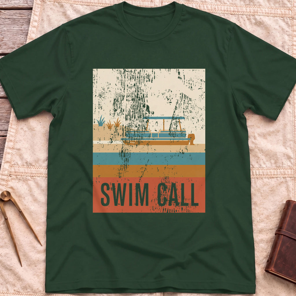 Front view of the forest green Swim Call T-Shirt with a distressed retro poster of a canopied pontoon boat over striped water above the words Swim Call.