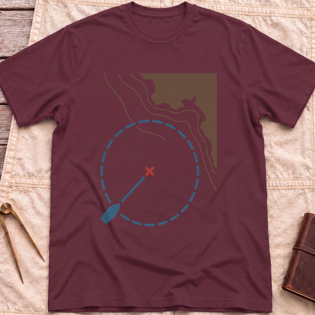 Front view of the maroon Swing Circle T-Shirt with a boat on a line inside a dashed circle around a red cross, beside a stretch of coastline.