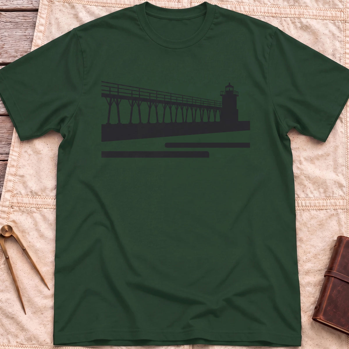 Front view of the forest green The Catwalk T-Shirt with a silhouette of a raised walkway running along a pier to a lighthouse.