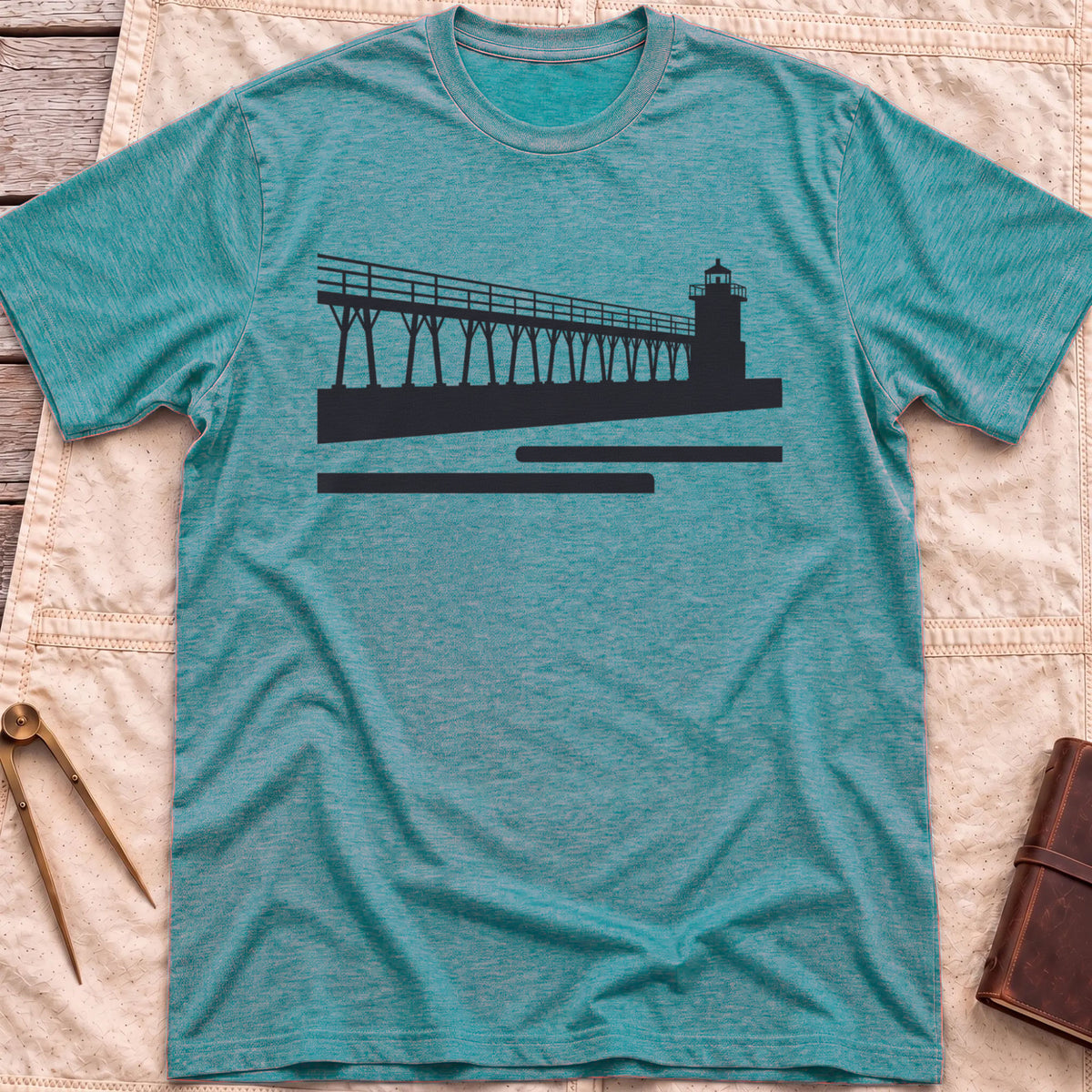 Front view of the heather galapagos blue The Catwalk T-Shirt with a silhouette of a raised walkway running along a pier to a lighthouse.