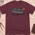 Front view of the maroon The Family Car T-Shirt with a small open boat fitted with a red outboard motor.