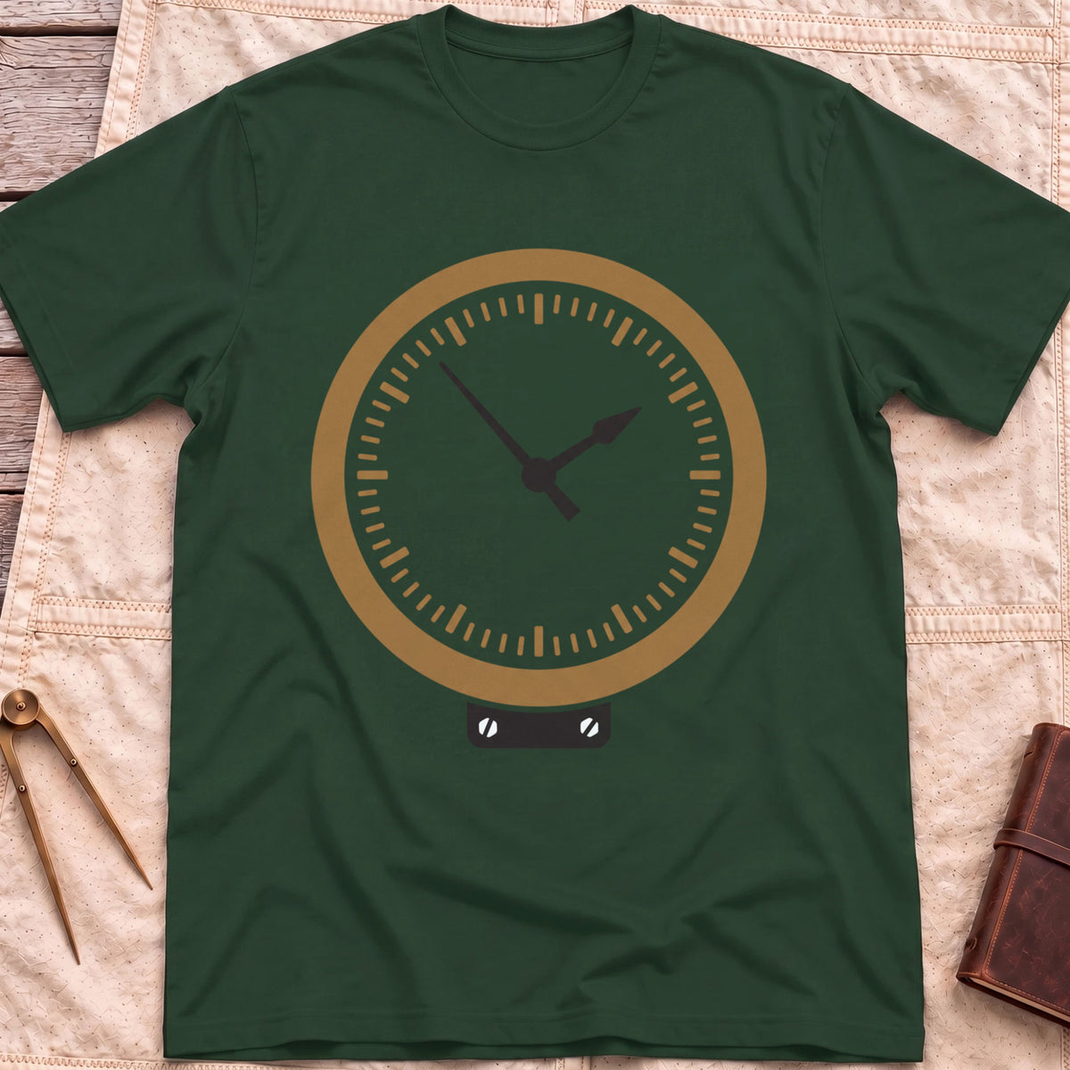 Front view of the forest green The Glass T-Shirt with a round brass-rimmed dial and two hands on a small mounting plate.