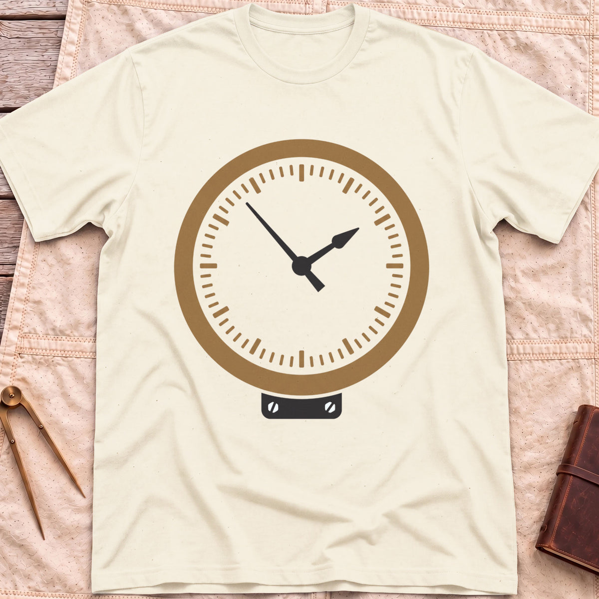 Front view of the natural The Glass T-Shirt with a round brass-rimmed dial and two hands on a small mounting plate.