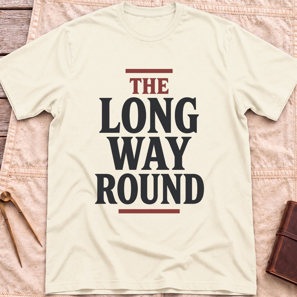 Front view of the natural The Long Way Round T-Shirt with the words The Long Way Round in heavy serif capitals between red rules.