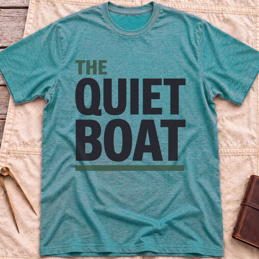 Front view of the heather galapagos blue The Quiet Boat T-Shirt with the words The Quiet Boat in heavy capitals above a green underline.