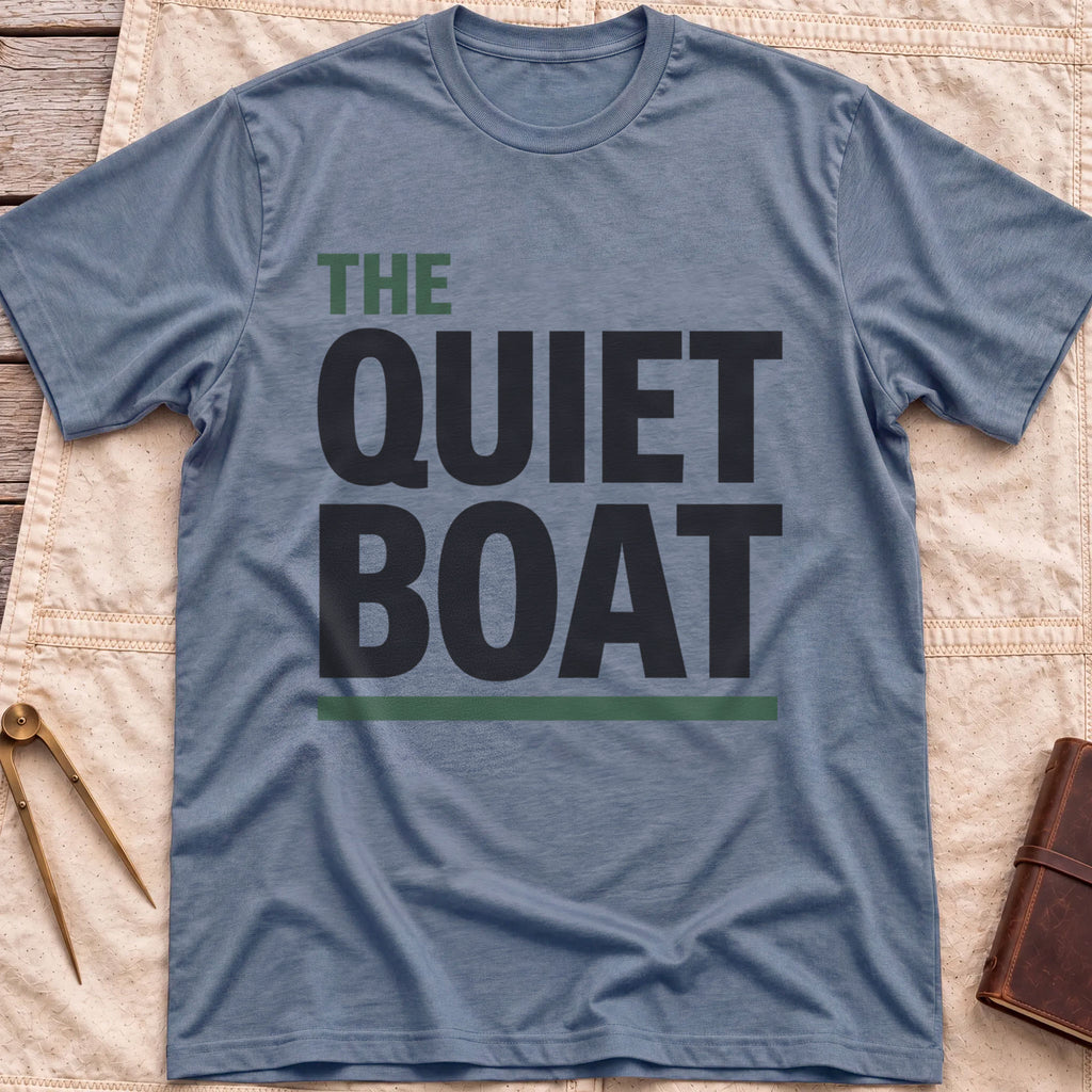 Front view of the heather indigo The Quiet Boat T-Shirt with the words The Quiet Boat in heavy capitals above a green underline.