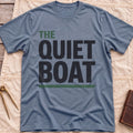 Front view of the heather indigo The Quiet Boat T-Shirt with the words The Quiet Boat in heavy capitals above a green underline.