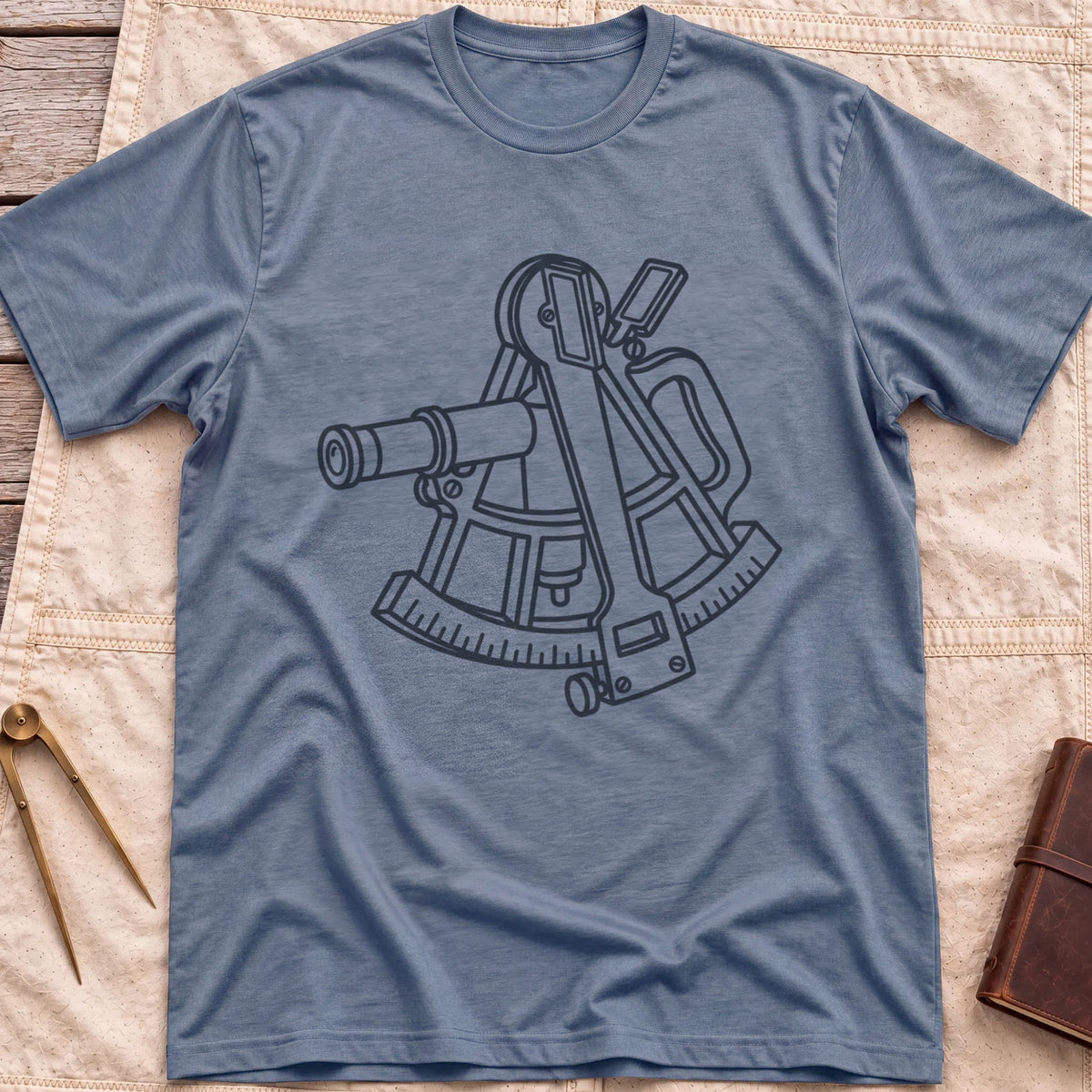 Front view of the heather indigo The Sextant T-Shirt with a line drawing of a sextant.
