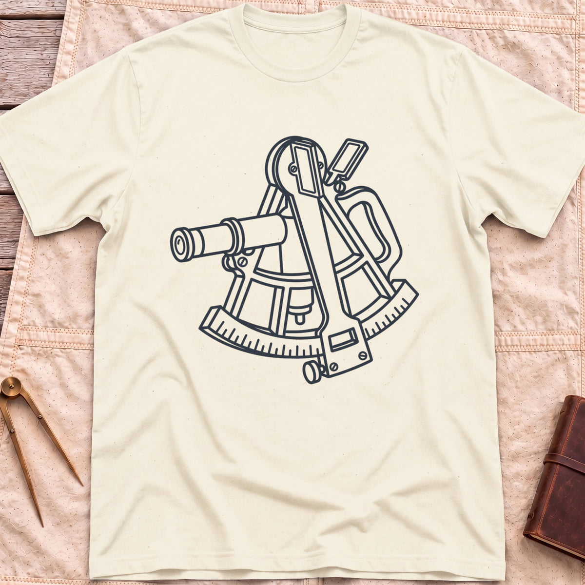 Front view of the natural The Sextant T-Shirt with a line drawing of a sextant.