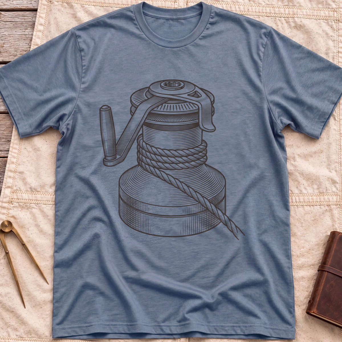 Front view of the heather indigo The Winch T-Shirt with a detailed illustration of a winch wrapped in rope, with its handle.