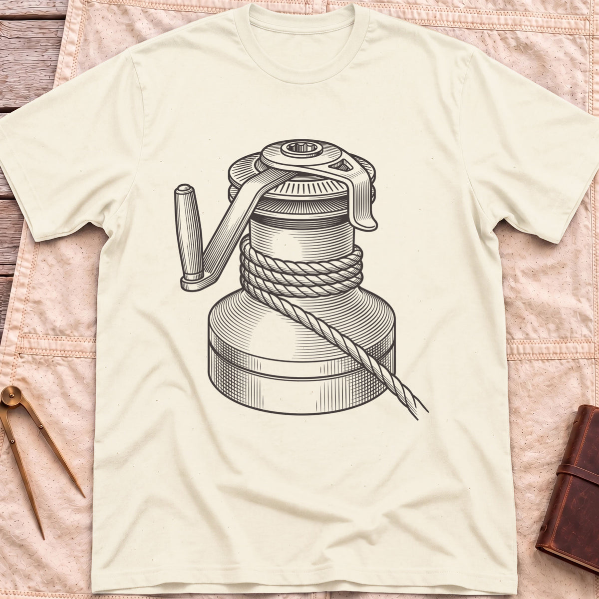 Front view of the natural The Winch T-Shirt with a detailed illustration of a winch wrapped in rope, with its handle.