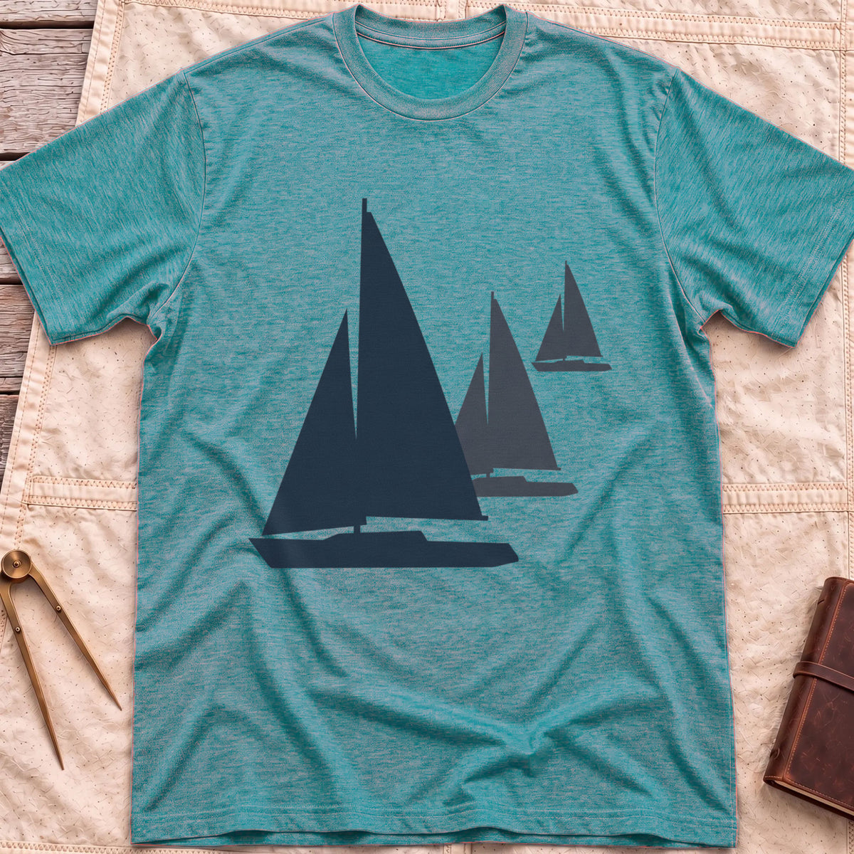 Front view of the heather galapagos blue Three Sails T-Shirt with silhouettes of three sailboats in decreasing sizes.