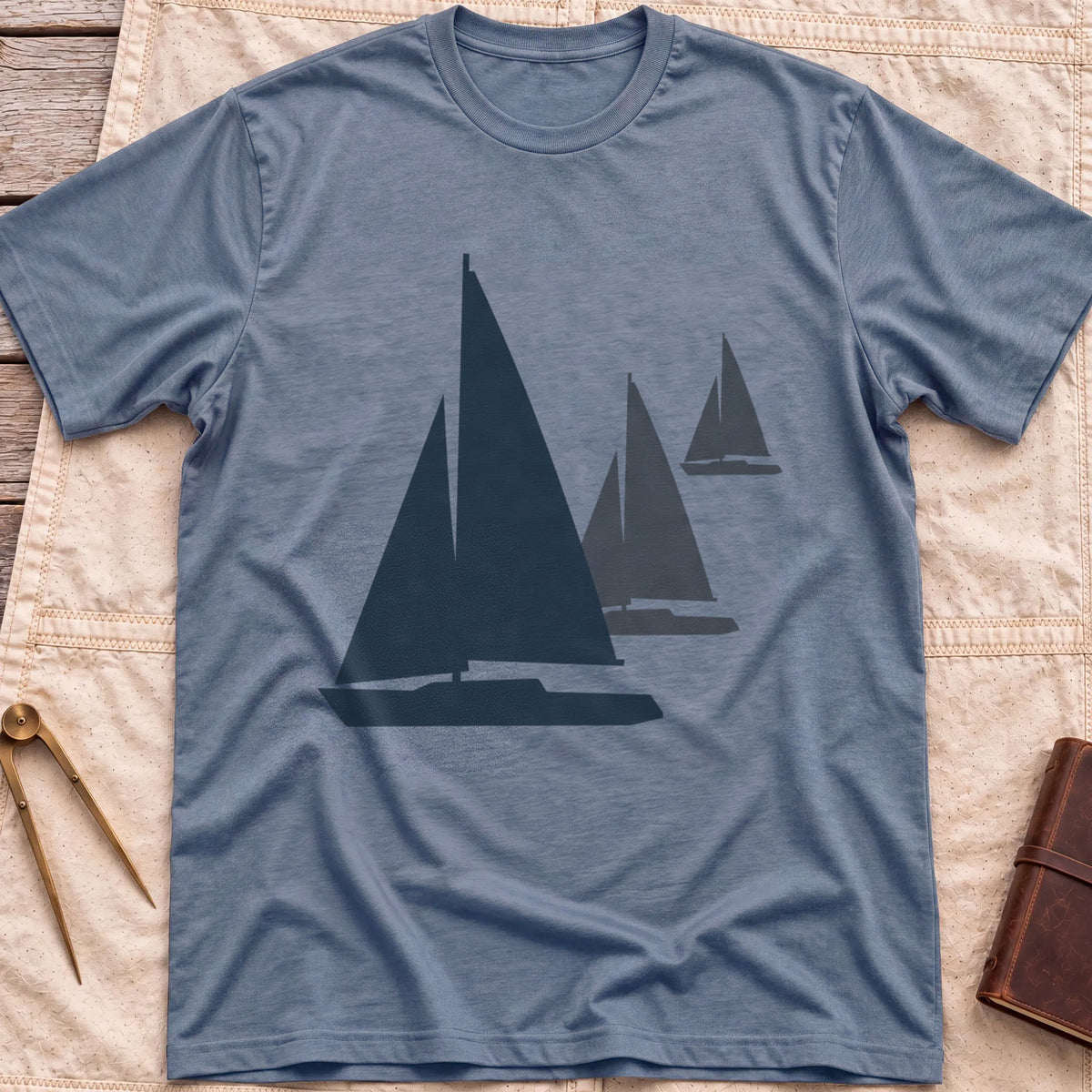 Front view of the heather indigo Three Sails T-Shirt with silhouettes of three sailboats in decreasing sizes.