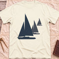 Front view of the natural Three Sails T-Shirt with silhouettes of three sailboats in decreasing sizes.