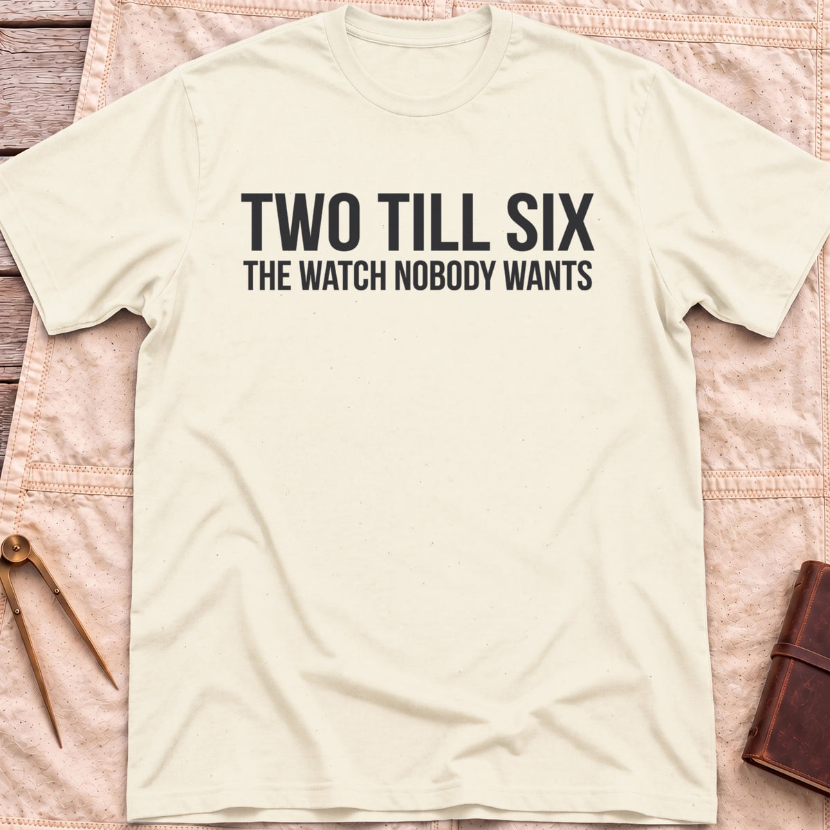 Front view of the natural Two Till Six T-Shirt with the words Two Till Six above The Watch Nobody Wants.