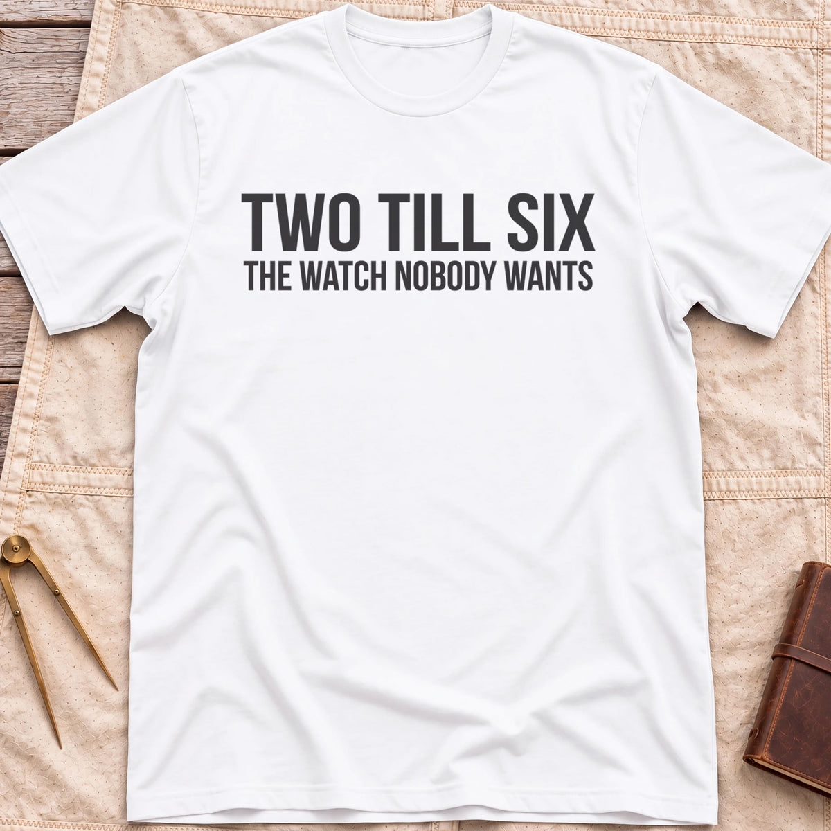 Front view of the white Two Till Six T-Shirt with the words Two Till Six above The Watch Nobody Wants.
