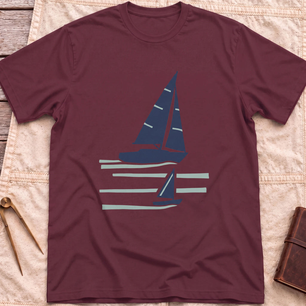 Front view of the maroon Two Wake T-Shirt with a large and a small sailboat over pale wake lines.