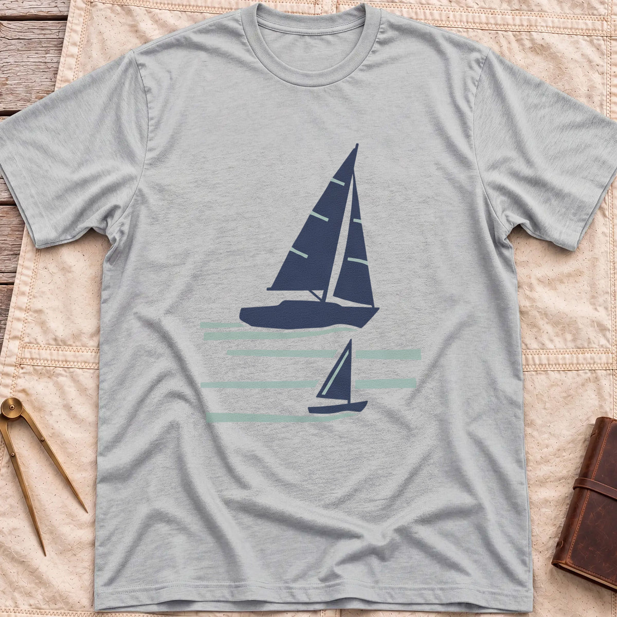 Front view of the sport grey Two Wake T-Shirt with a large and a small sailboat over pale wake lines.