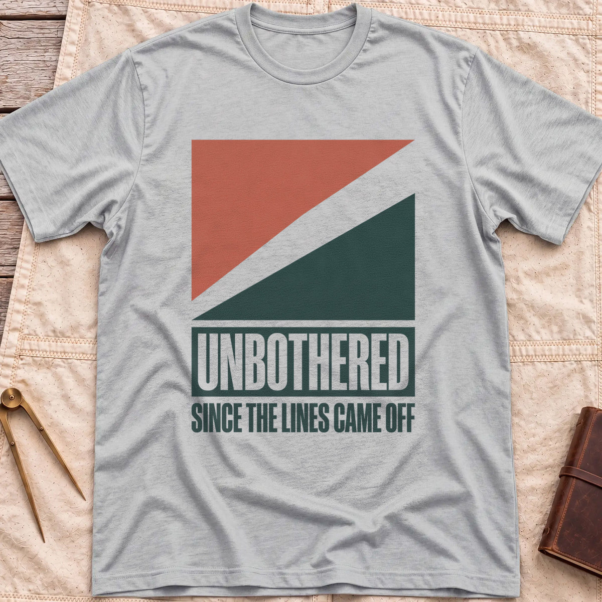 Front view of the sport grey Unbothered T-Shirt with rust-red and dark green diagonal blocks above the words Unbothered, Since the Lines Came Off.
