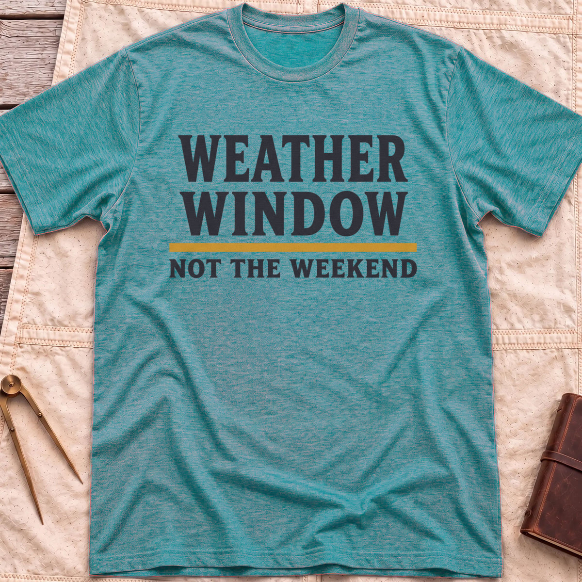 Front view of the heather galapagos blue Weather Window T-Shirt with the words Weather Window above a tan rule and Not the Weekend.