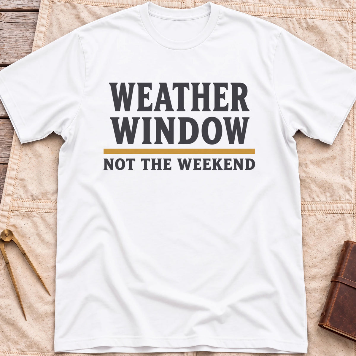 Front view of the white Weather Window T-Shirt with the words Weather Window above a tan rule and Not the Weekend.