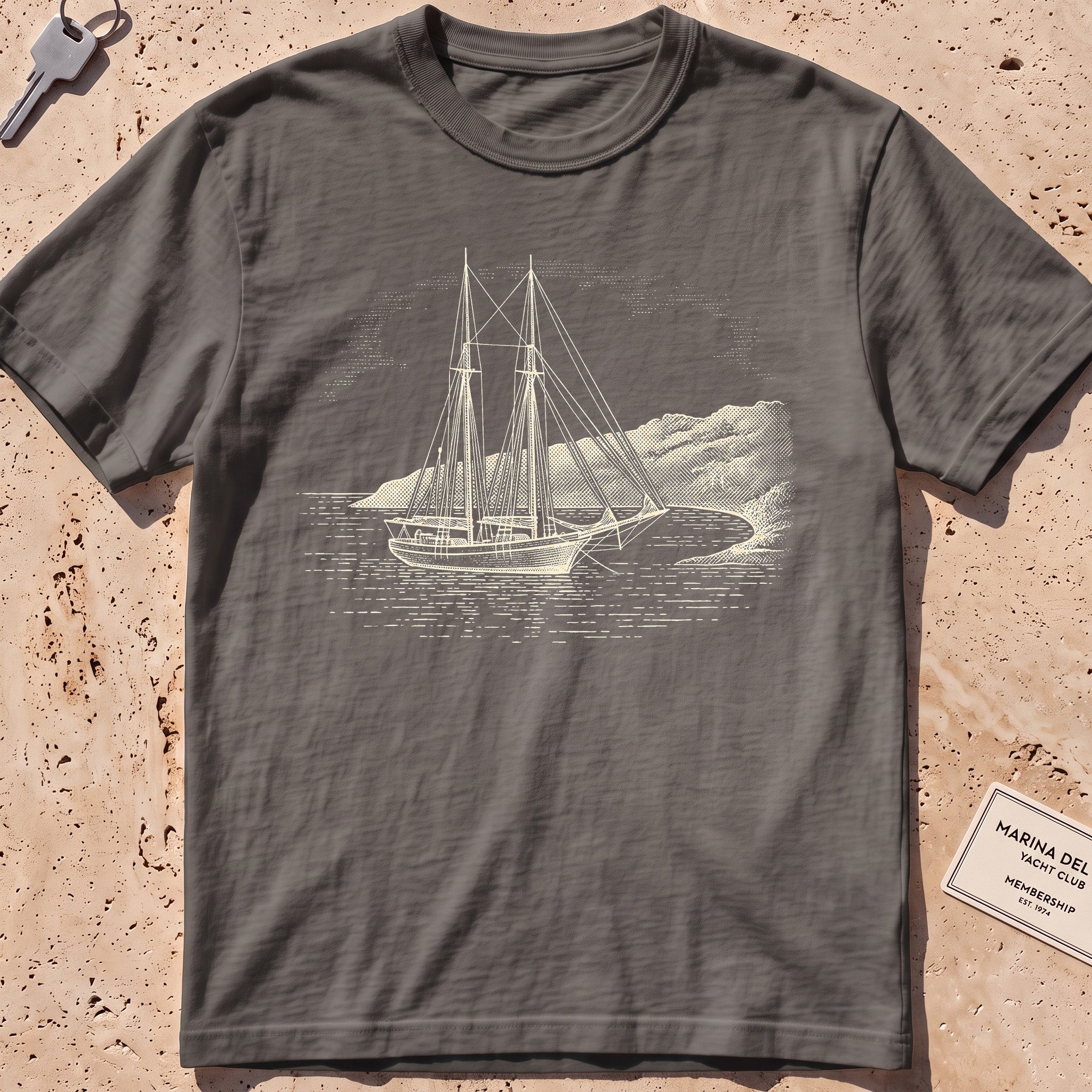pepper heavyweight tee with an etched schooner moored in a cove graphic.