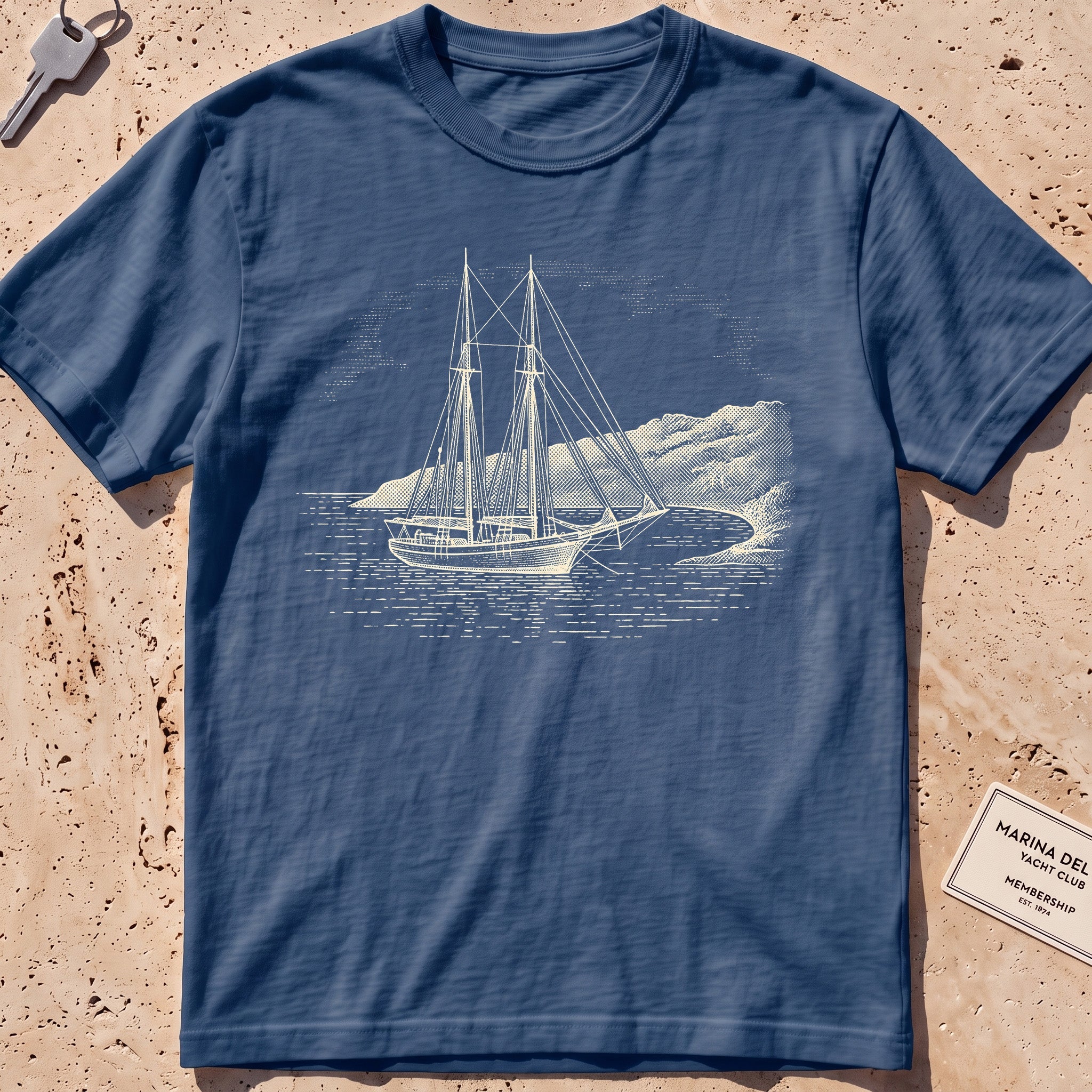 midnight heavyweight tee with an etched schooner moored in a cove graphic.