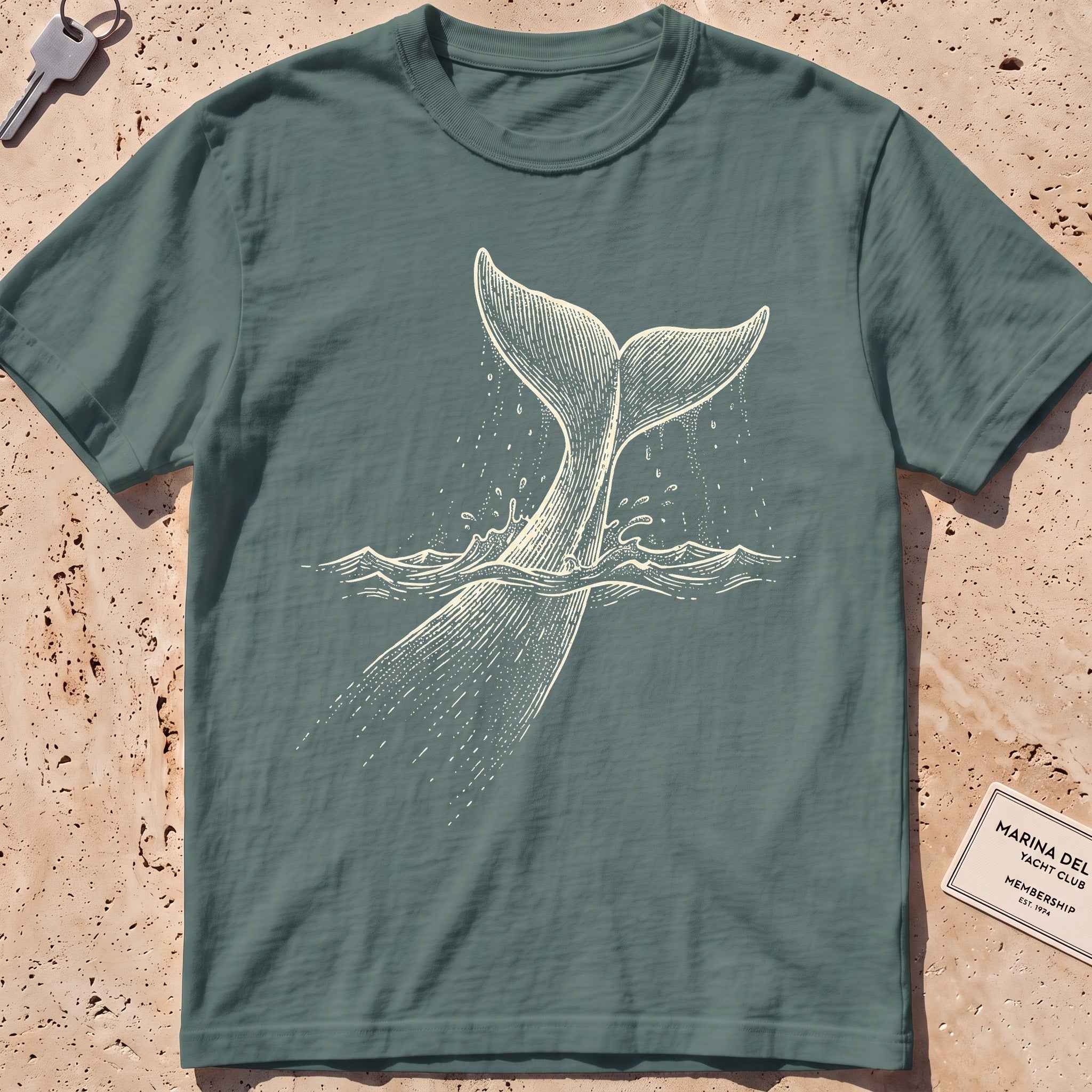 blue spruce heavyweight tee with an etched sperm whale diving deep graphic.