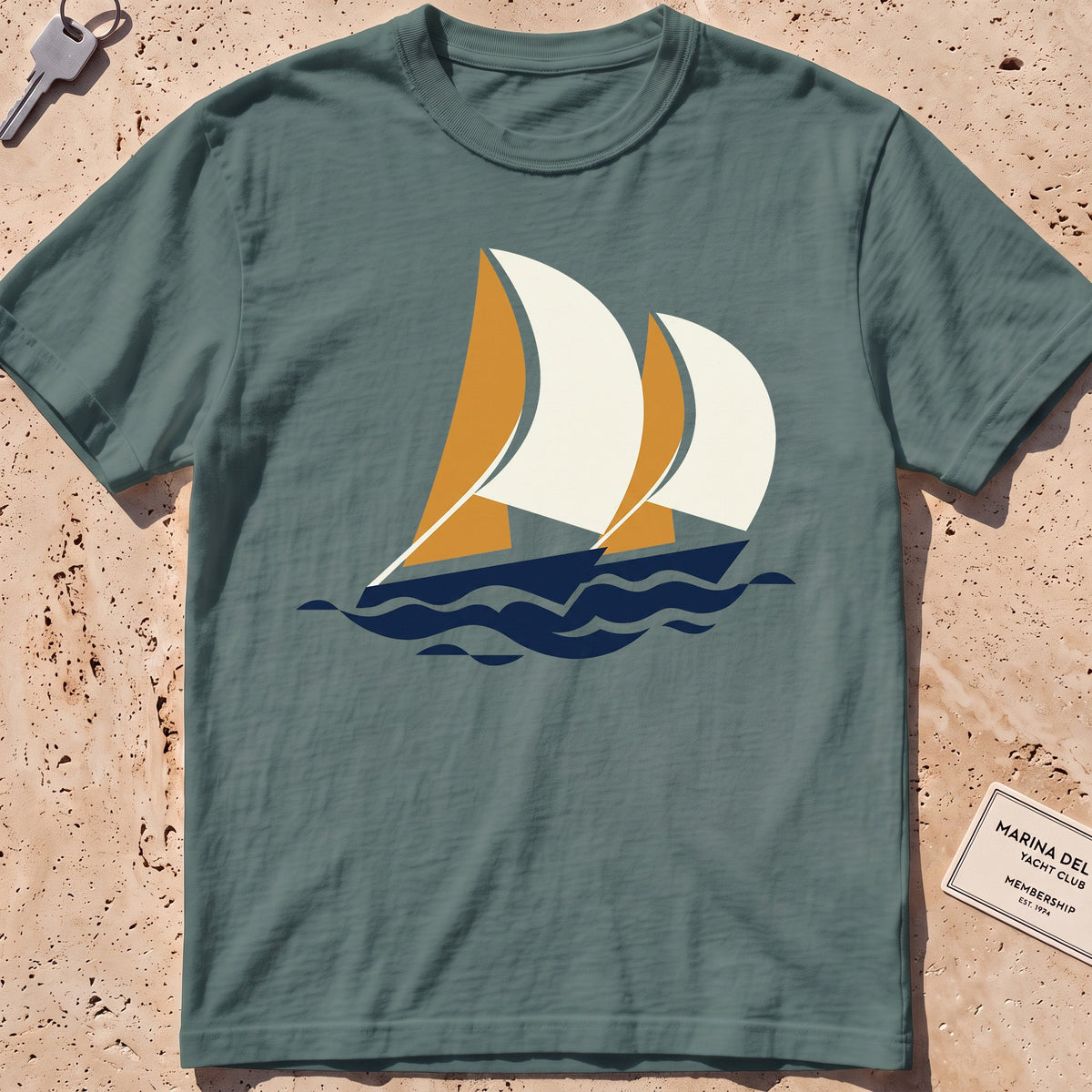 blue spruce heavyweight tee with flat-geometric racing spinnakers graphic.
