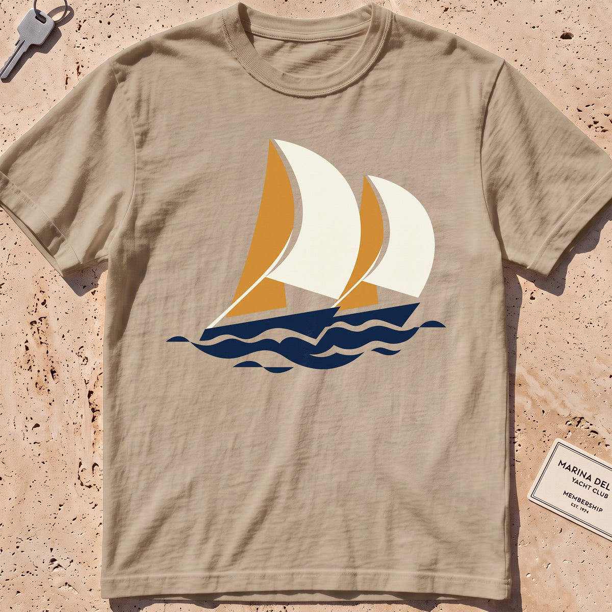 khaki heavyweight tee with flat-geometric racing spinnakers graphic.