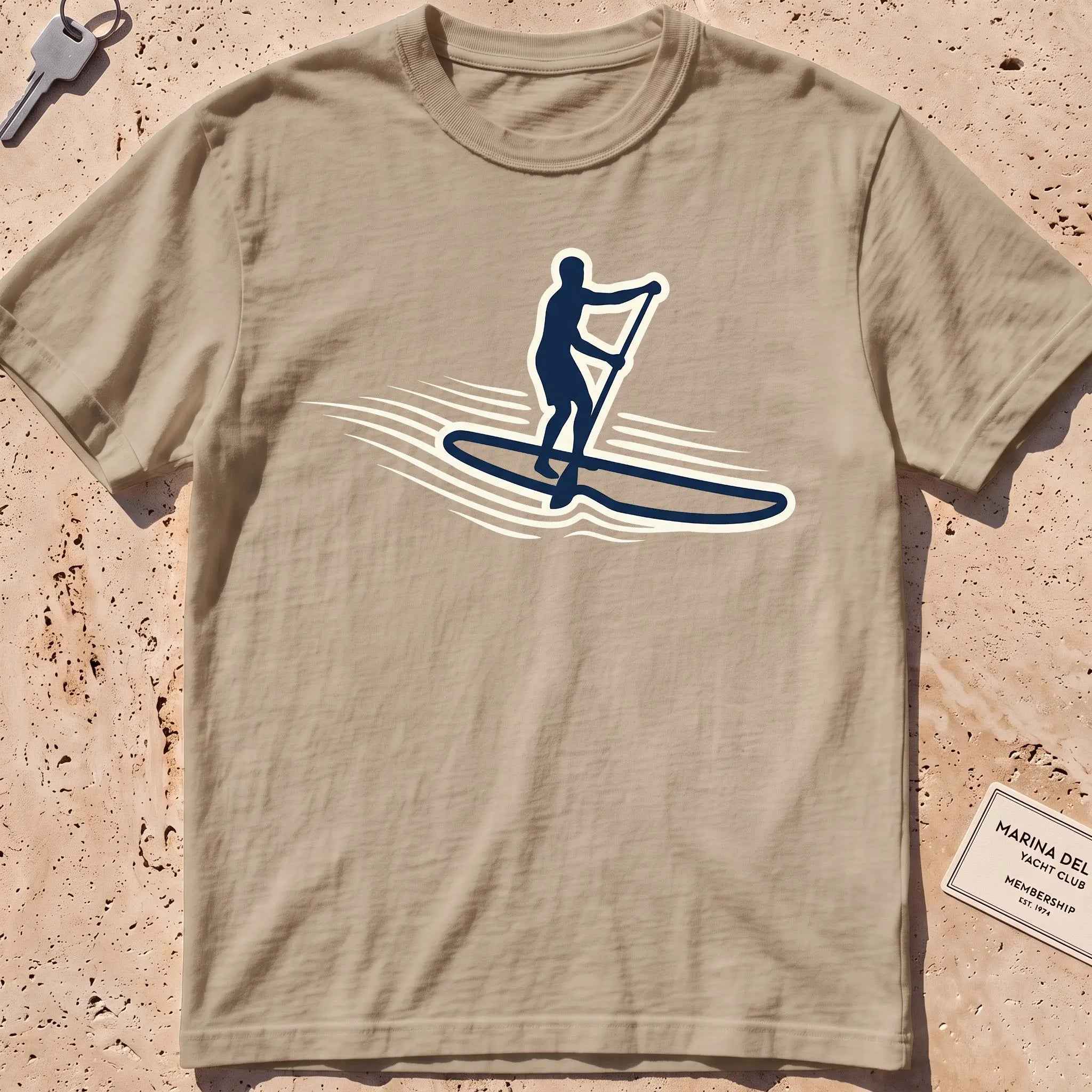 khaki heavyweight tee with a stand-up paddleboarder "Standing Calm" graphic.