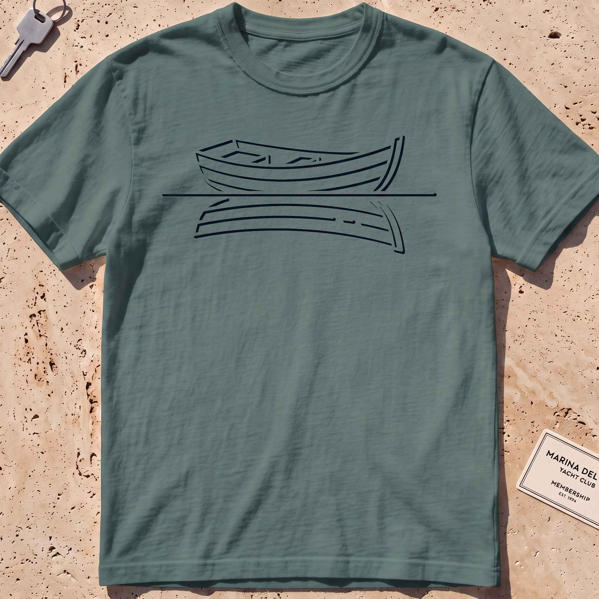 blue spruce heavyweight tee with a single-line rowboat and still-water reflection.