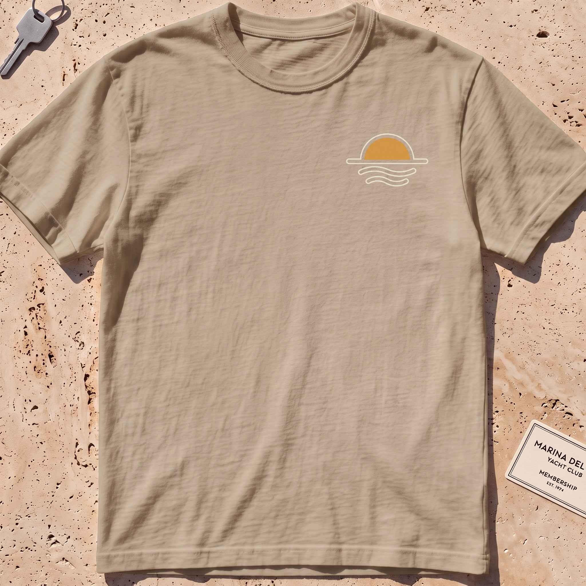 khaki heavyweight tee with a sun-and-waves crest graphic.
