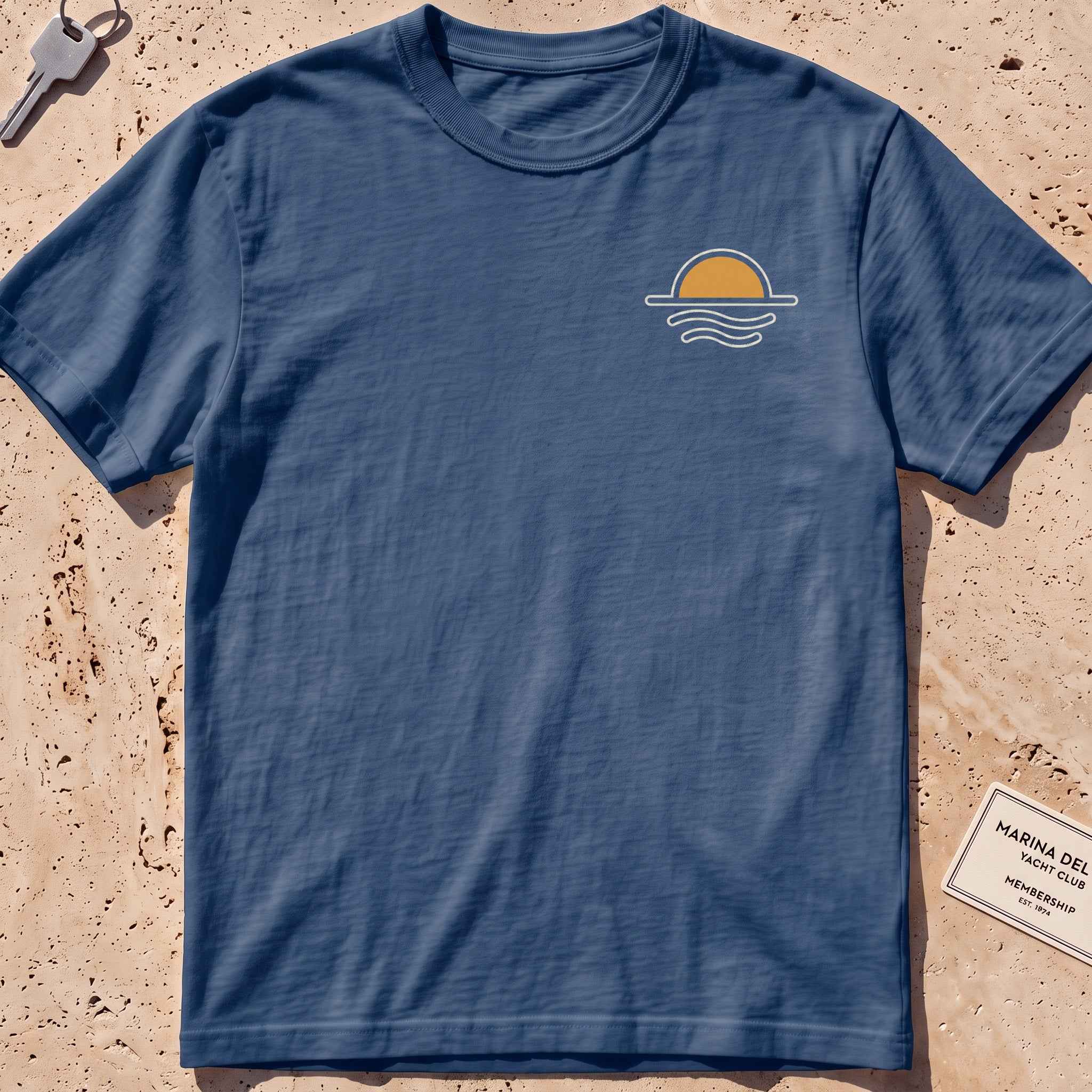 midnight heavyweight tee with a sun-and-waves crest graphic.