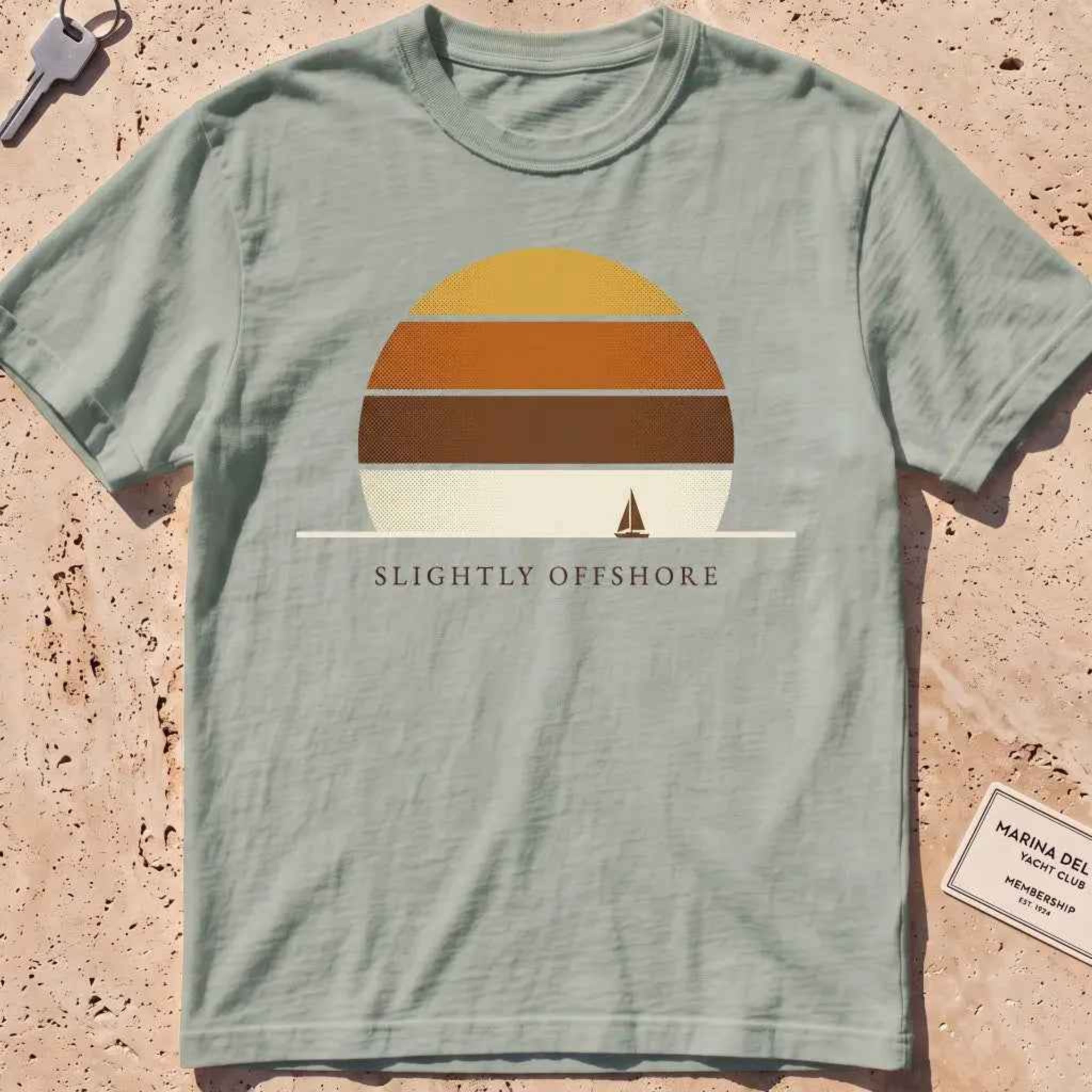 bay heavyweight tee with a striped sun disc and tiny sailboat graphic.