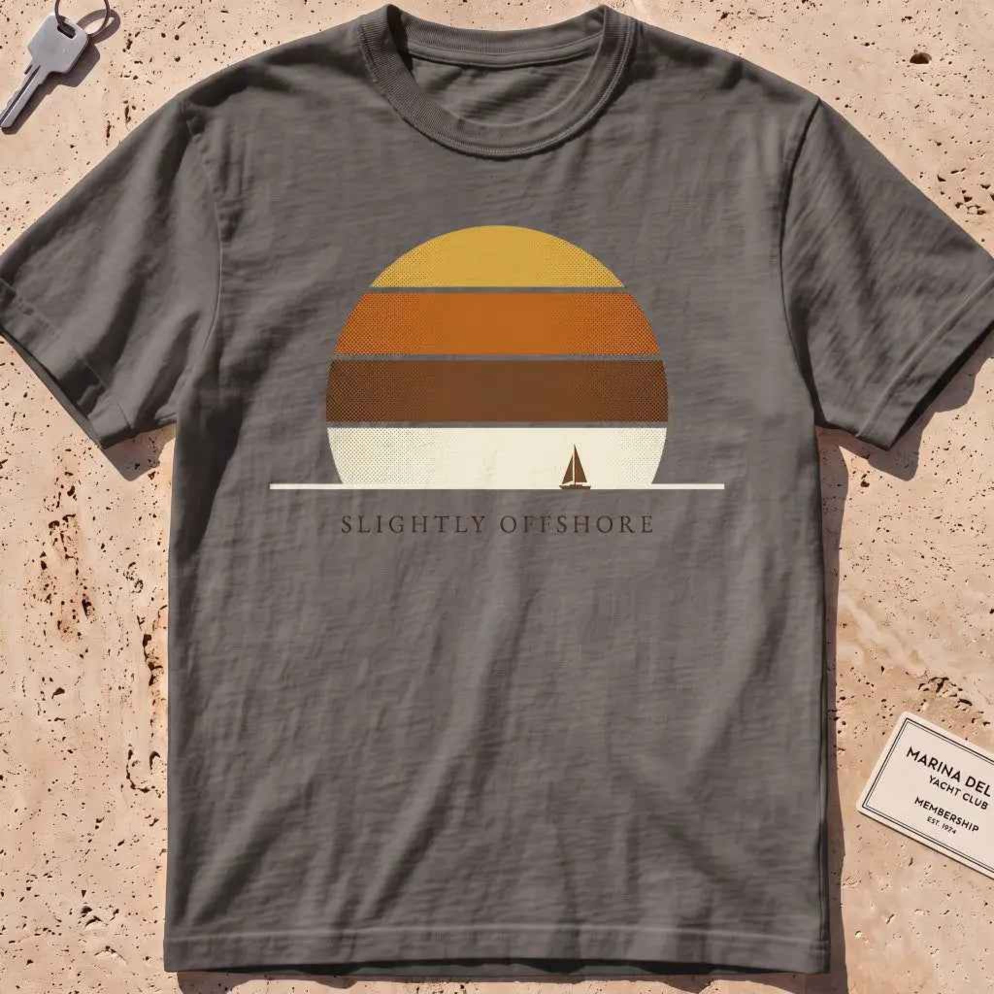 pepper heavyweight tee with a striped sun disc and tiny sailboat graphic.
