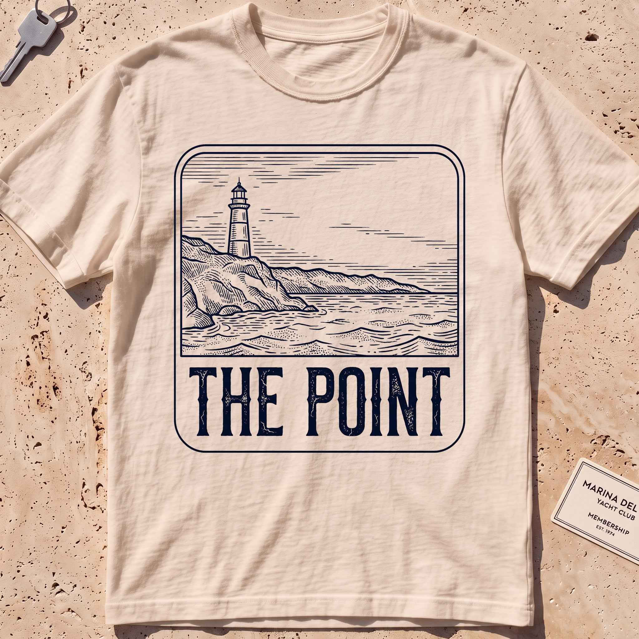 ivory heavyweight tee with an etched lighthouse point badge graphic.