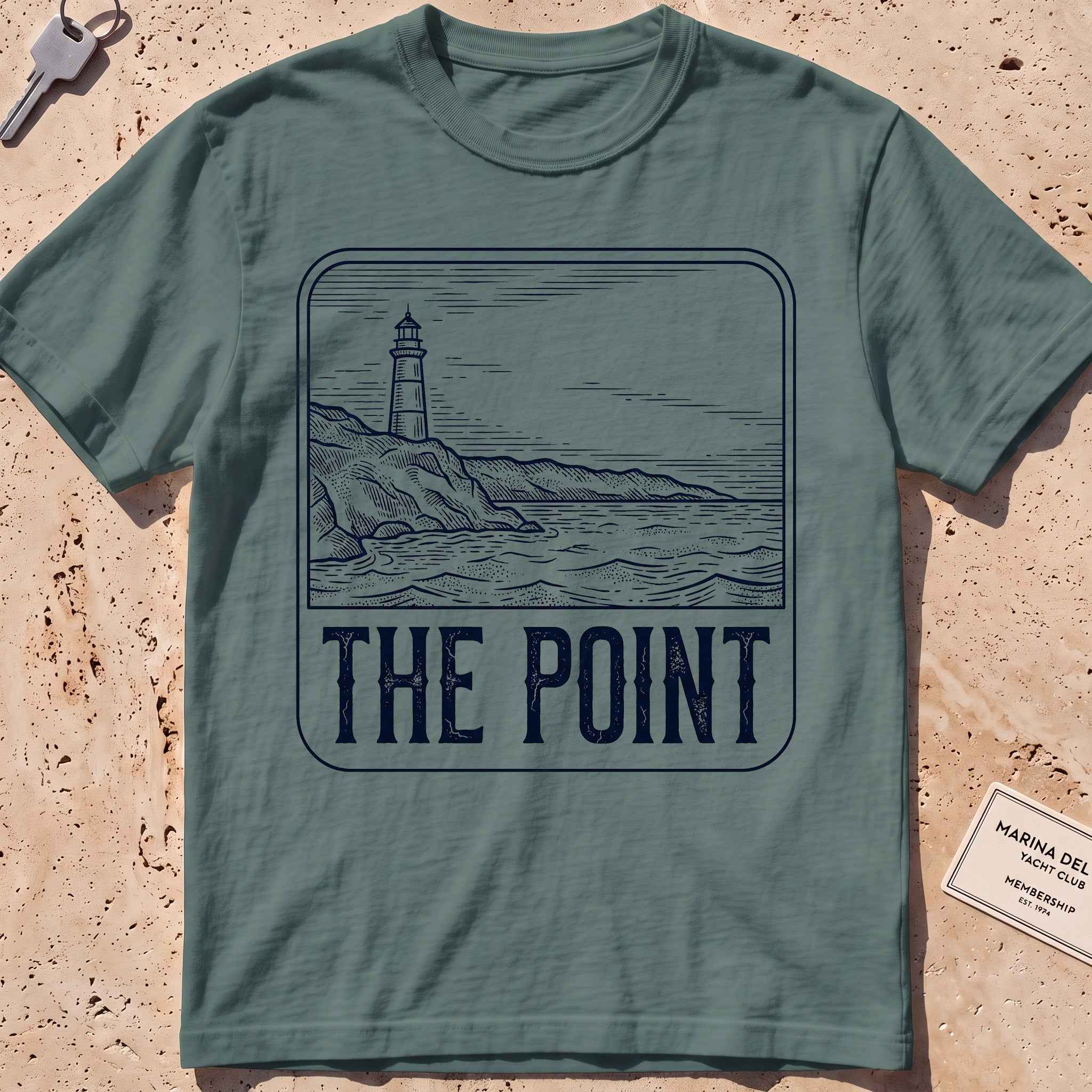 blue spruce heavyweight tee with an etched lighthouse point badge graphic.