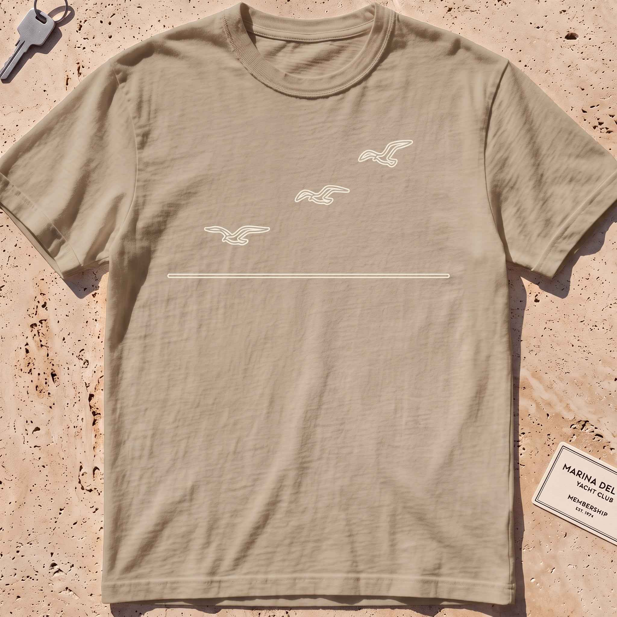 khaki heavyweight tee with three single-line gulls in flight graphic.
