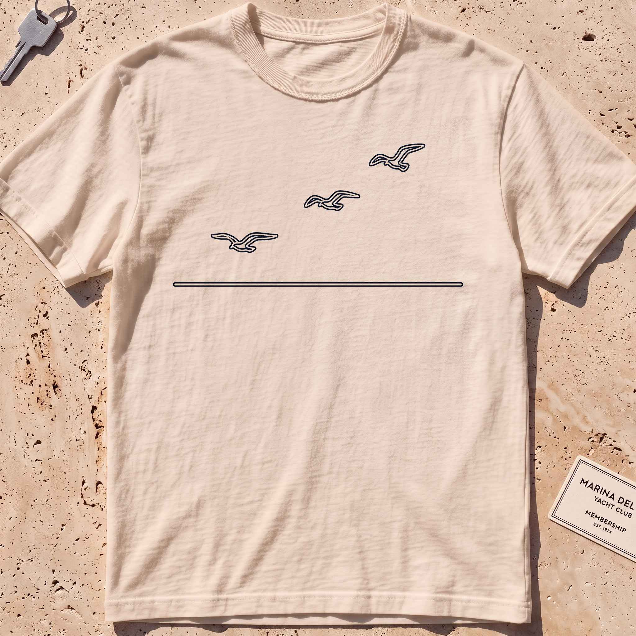 ivory heavyweight tee with three single-line gulls in flight graphic.
