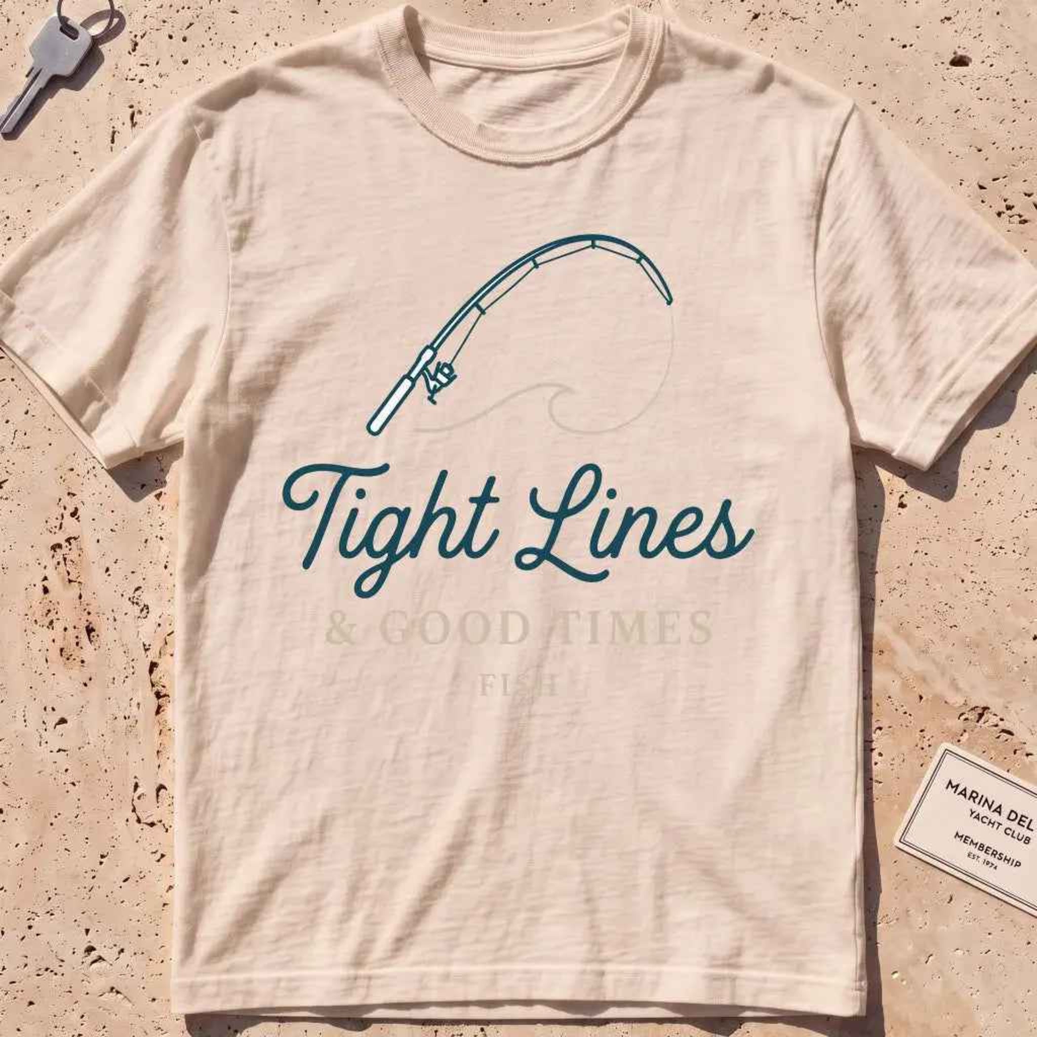 ivory heavyweight tee with a bent rod and "Tight Lines and Good Times" script.