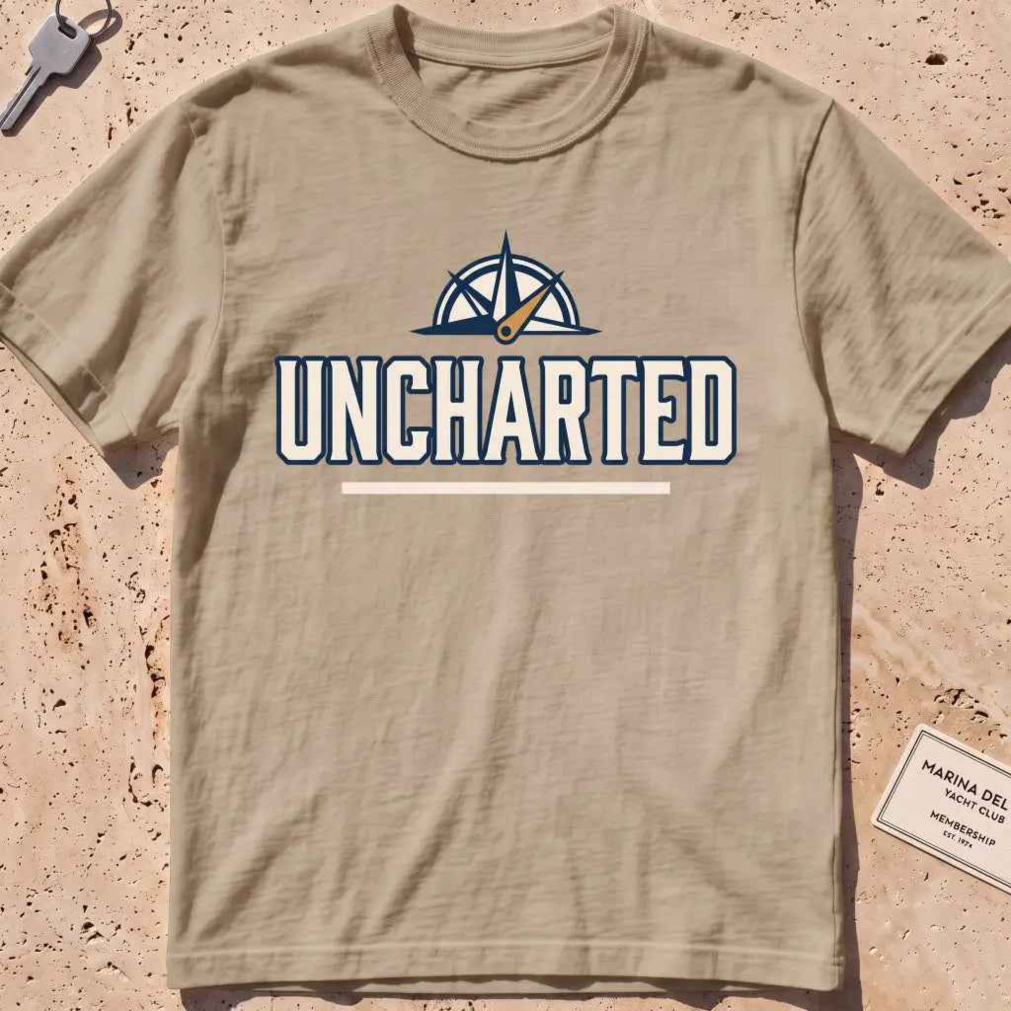 khaki heavyweight tee with a compass and bold "Uncharted" exploration type.