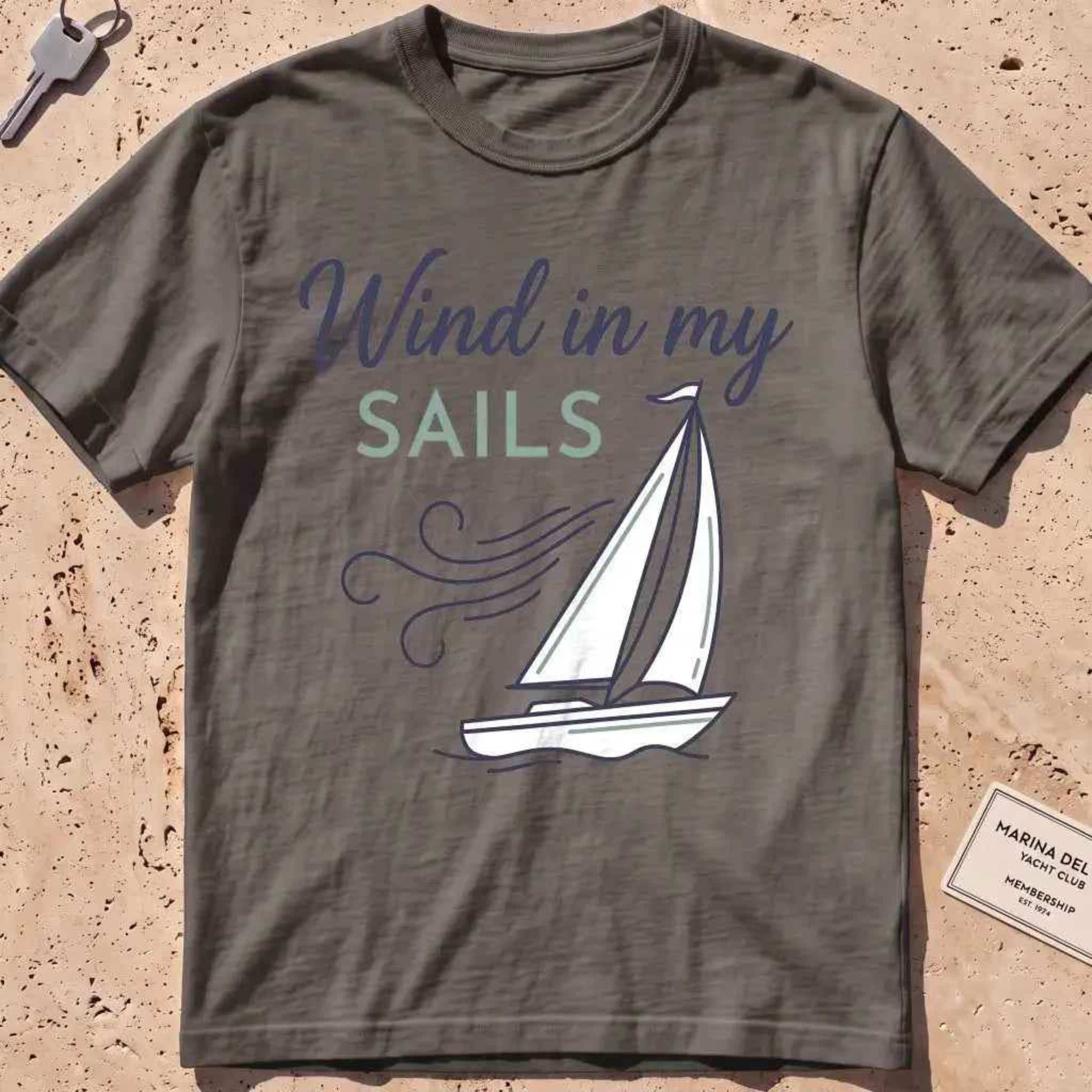 pepper heavyweight tee with a line-art sailboat "Wind in My Sails" graphic.