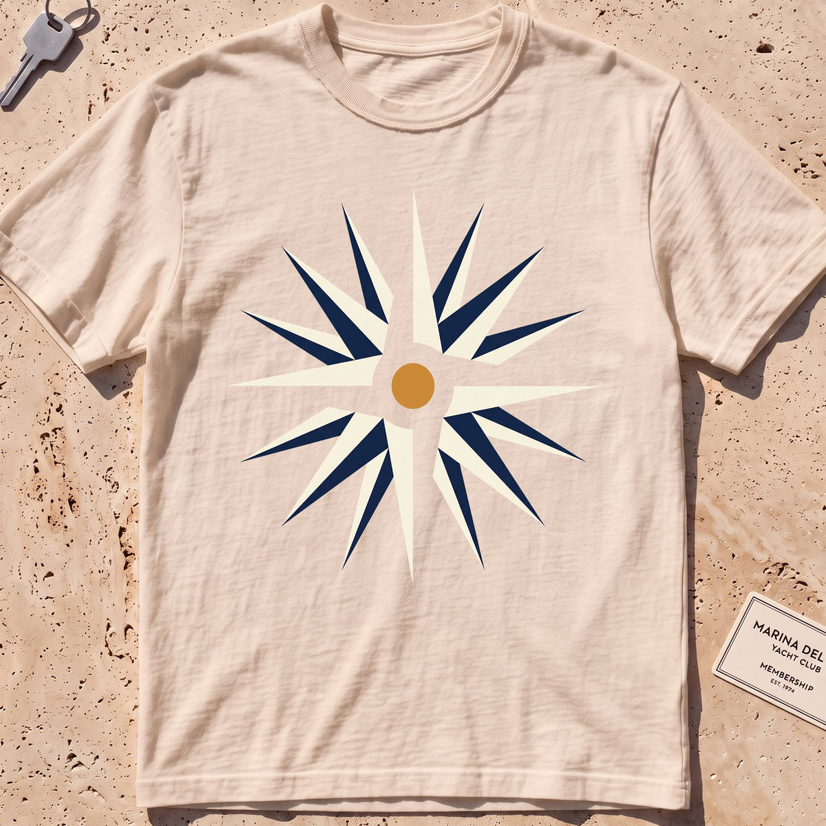ivory heavyweight tee with a flat-geometric wind rose graphic.