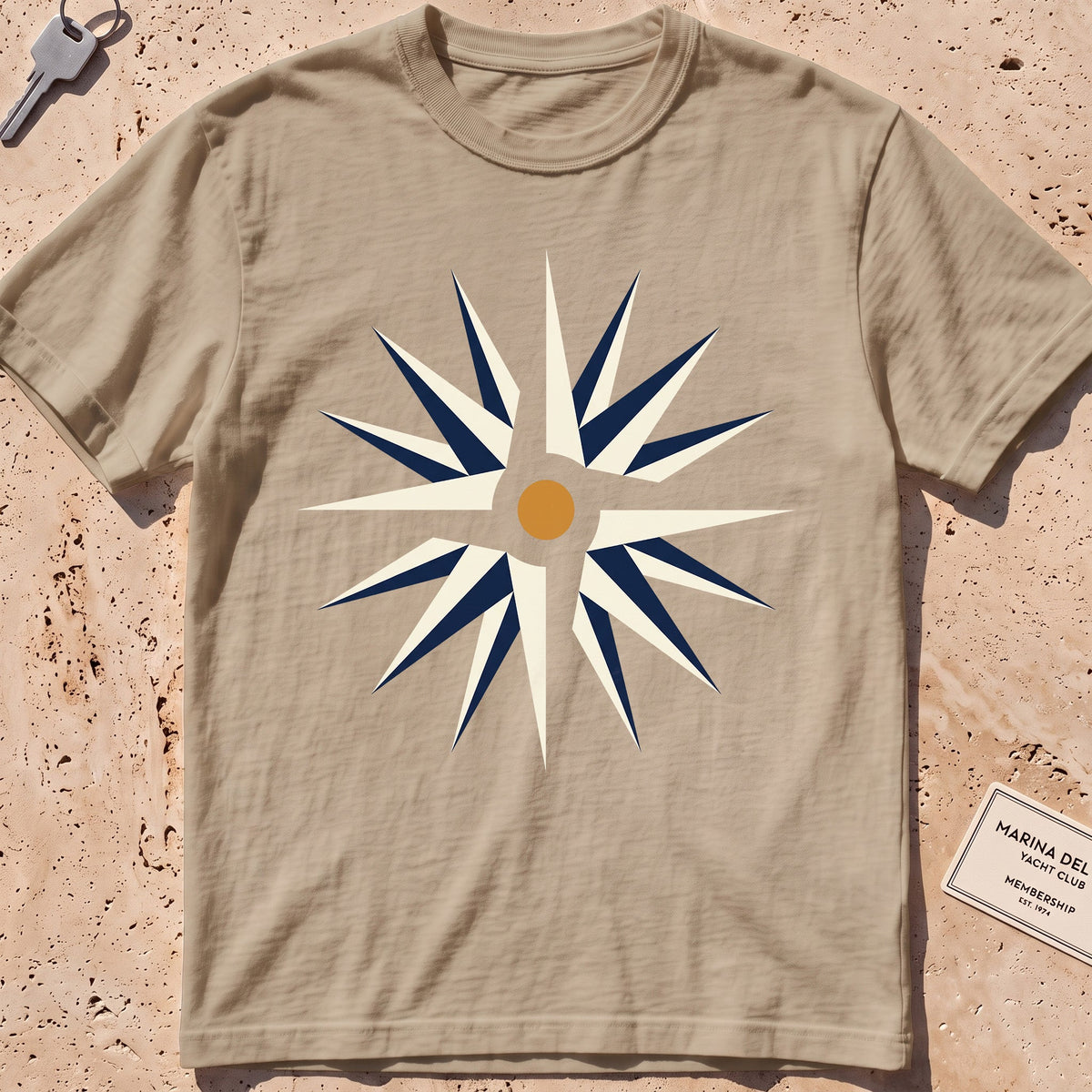 khaki heavyweight tee with a flat-geometric wind rose graphic.